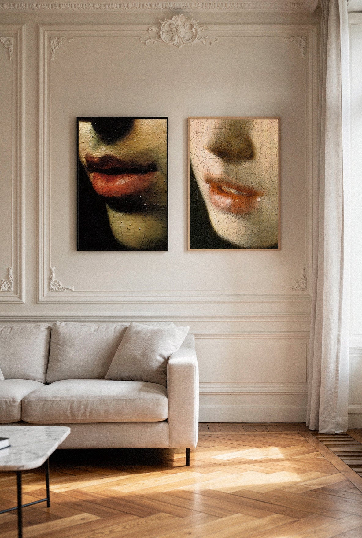 Living room with a beige sofa and wall art depicting faces.