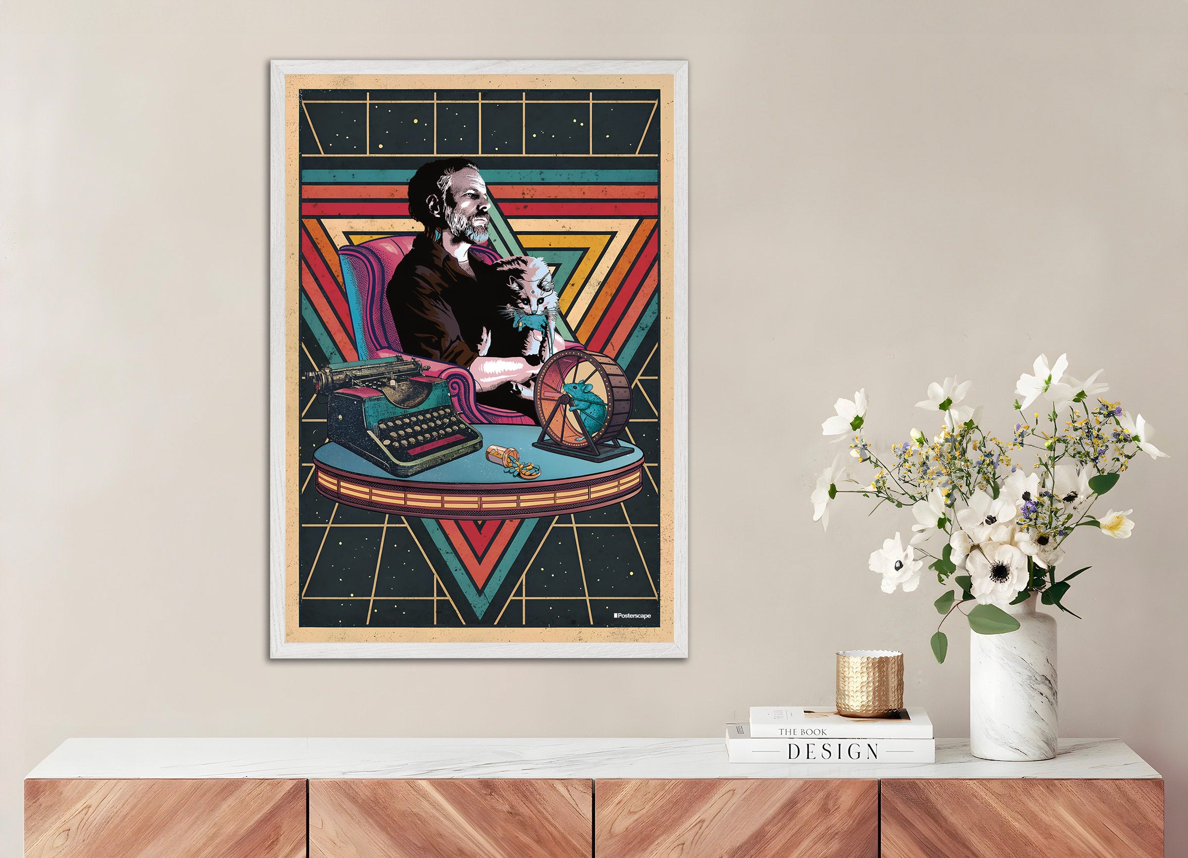 Framed artwork of the writer Philip K. Dick with a cat on a typewriter against a geometric pattern, displayed on a wall above a wooden shelf.